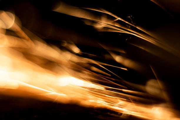 abstract close-up image of blurred sparks and smoke from arc welding with bokeh effect
