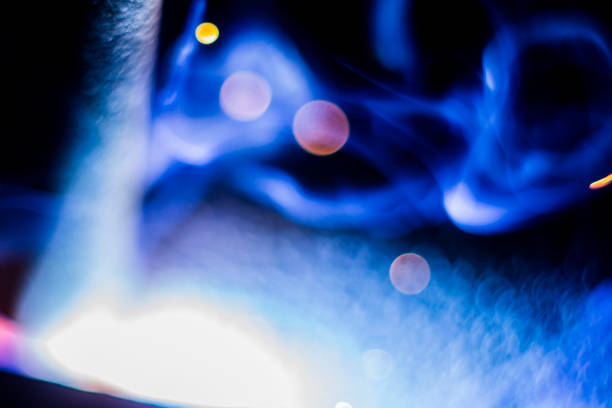 abstract close-up image of blurred sparks and smoke from arc welding with bokeh effect