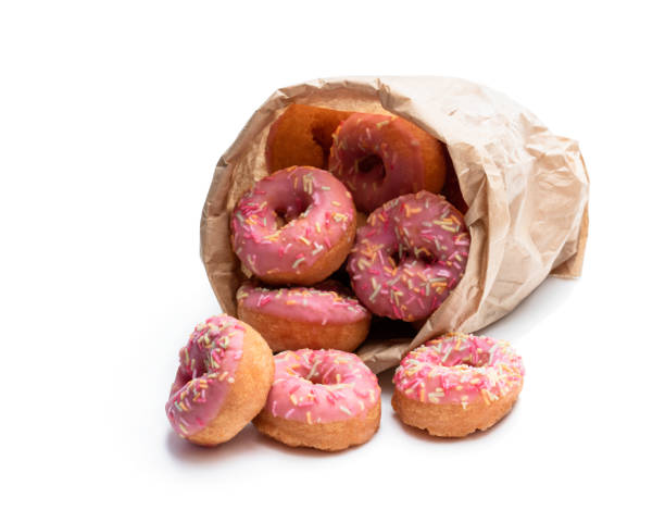 istock Mini pink glazed doughnuts in paper bag isolated on white 1186752727