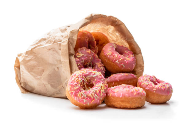 istock Mini pink glazed doughnuts in paper bag isolated on white 1186752741