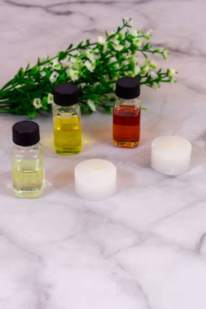 istock Essential oils over marble background with white flowers and copy space in portrait position. Flat lay 1186755098