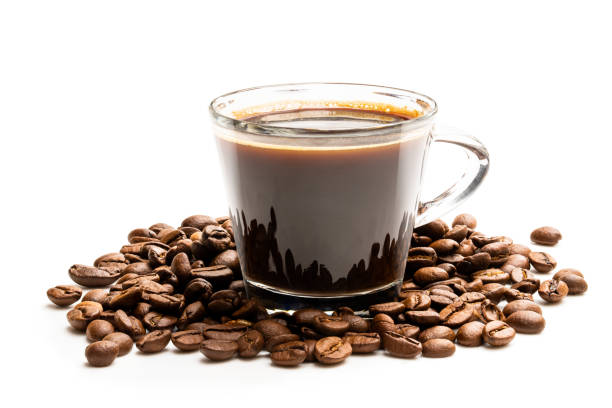 istock Black coffee in glass cup with beans isolated on white 1186758280