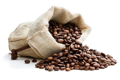 Roasted  coffee beans scattered of the burlap bag isolated on white