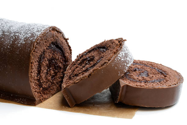 istock Chocolate yule log christmas cake coated with milk chocolate isolated on white 1186759478