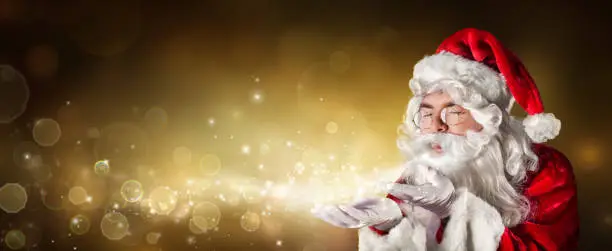 Santa Claus Wishing Magic Christmas Lights In Golden Shiny Background
