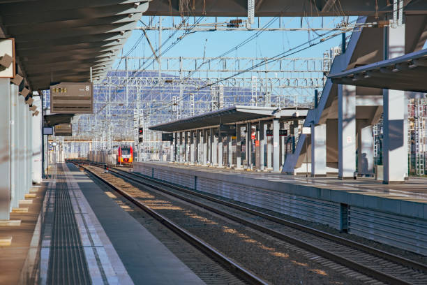 istock Passenger station with an empty platform without people, a train is visible in the distance. 1186761234