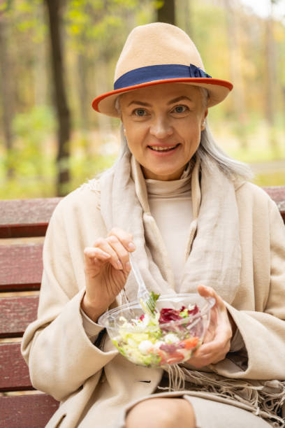 istock Stylish business lady eating in a park 1186763328