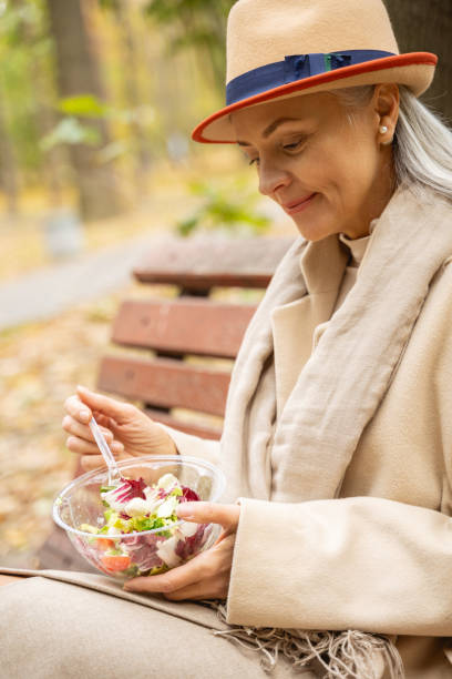 istock Lovely tranquil Caucasian lady enjoying her salad 1186763333