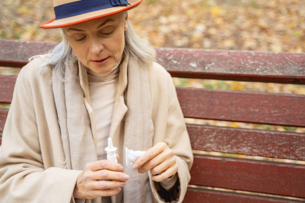 istock Low-spirited lady staring at her nasal spray 1186763337
