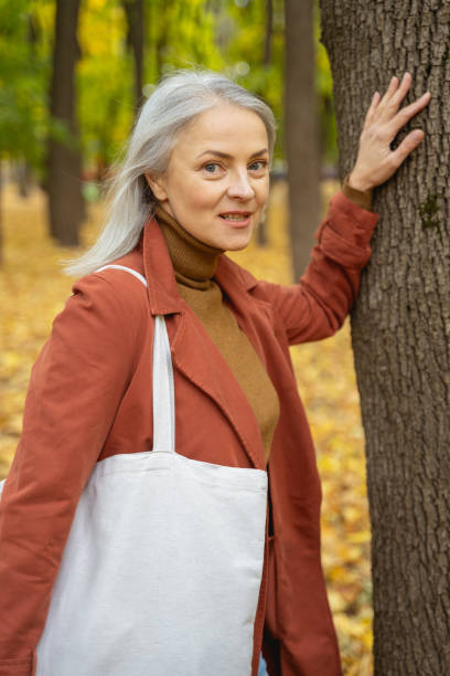 istock Mature beautiful lady standing in a park 1186763396