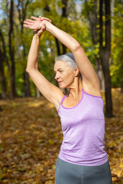 istock Focused Caucasian female doing side bends outdoors 1186763750