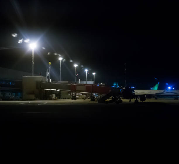 istock Passenger planes near hangar at night airport. 1186763861