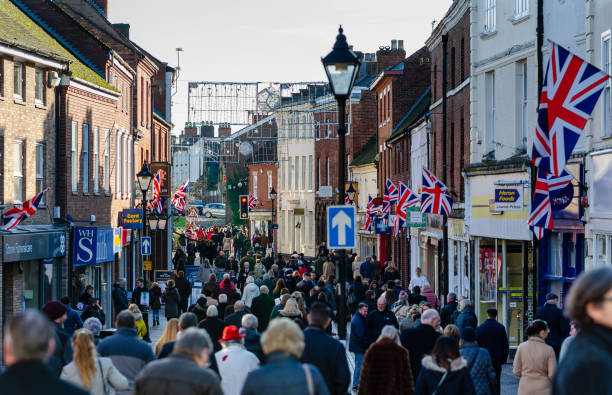 Photo a crowded street in a small British town after the Remembrance Day parade in Stone, Staffordshire, UK. Memorial day parade was well organised and took place in small town Stone, Staffordshire, UK. Armed forces and representatives of local organisations marched the High Street. Hundreds of local residents gathered on the streets for 2 minutes of silence and the prayer. stoke on trent stock pictures, royalty-free photos & images