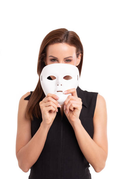Young woman taking off mask from face isolated on white