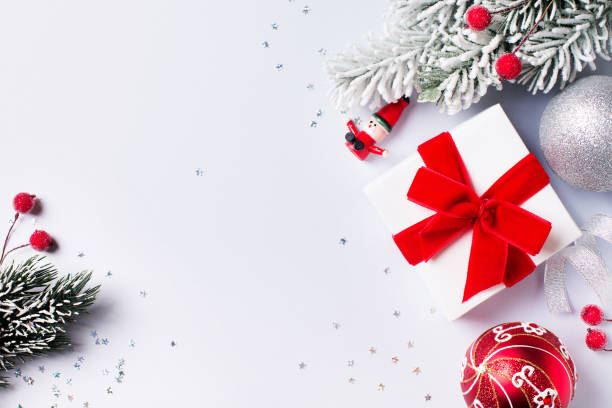 istock Christmas gift box flat lay on white background with decoration. 1186771055