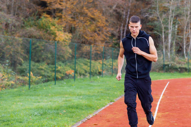 istock Man running on the race track 1186773722