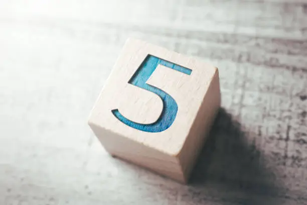 Photo of Number 5 On A Wooden Block On A Table