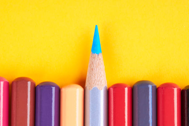 istock leadership teamwork concept. collection colored pencils on a yellow background with space. 1186775954