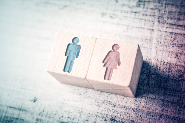 gender signs for male and female on wooden blocks on a table - sexuality imagens e fotografias de stock