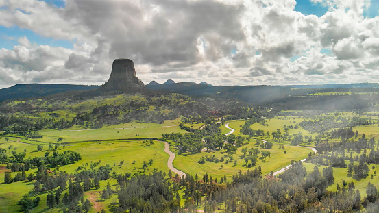 Devil's Tower National Monument and surrounding landscape in summer season. Beautiful aerial view on a sunny afternoon.