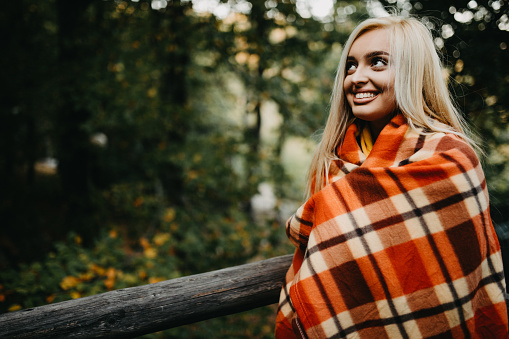 Happy sensual blonde  and smiling in the deep forest