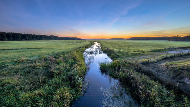 istock Sunset Landscape of lowland river 1186780978
