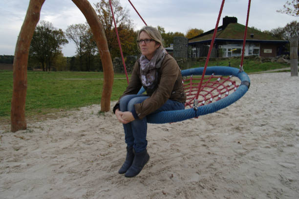 happy laughing woman on swing laughing.