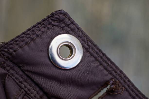 istock metal button rivet on brown fabric on clothes 1186788404