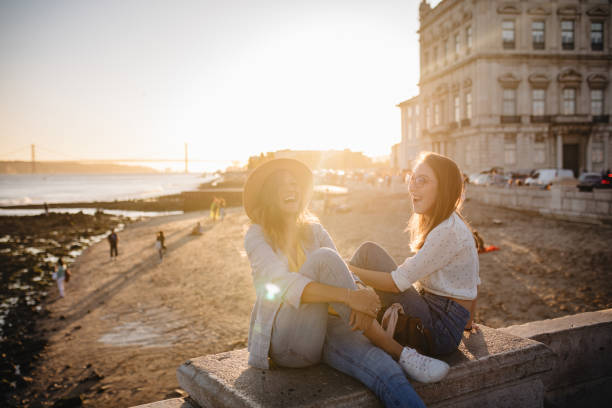Perfect day with my best friend Two happy smiling woman enjoying good time in Lisbon tejo trends her stock pictures, royalty-free photos & images