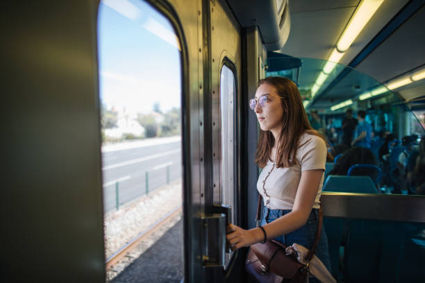 istock Young female tourist enjoying view from train windown 1186796641