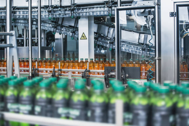 istock Plastic bottles with fresh organic juice on automatic conveyor belt or line in beverage factory or plant interior inside with modern industrial machine equipment 1186798059
