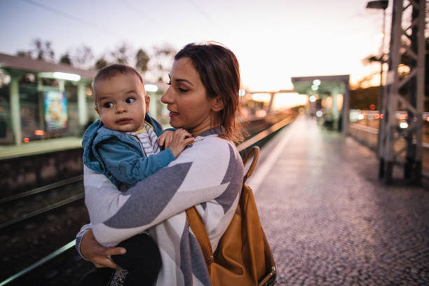 istock Mother and son waiting for passenger train 1186798196