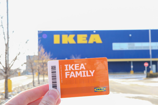 Winnipeg, Manitoba / Canada - November 7, 2019: Ikea Family Card in the First Plan with the Store Logo in the Background.