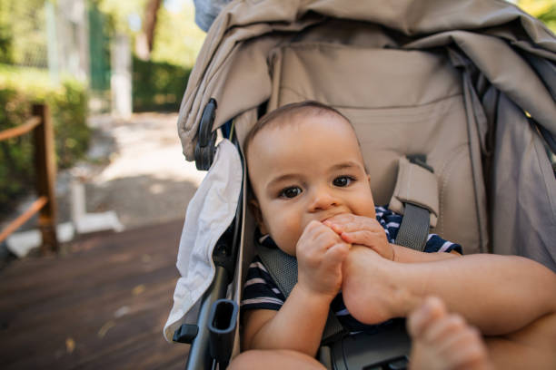 istock Curious baby boy putting his feet in mouth 1186803773