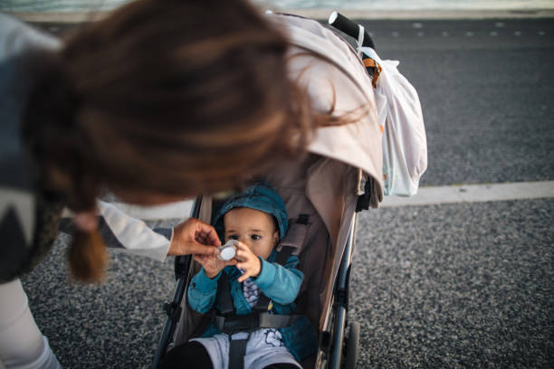 istock Mother putting pacifier in her son mouth 1186804209