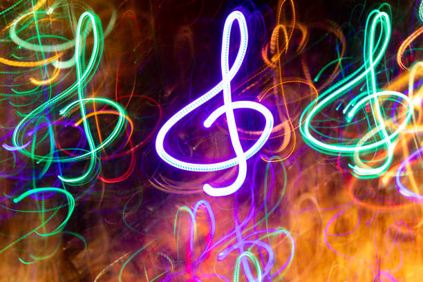 close-up lot of multicolored neon glowing treble clefs. abstract  luminous background. - large group of people flash imagens e fotografias de stock