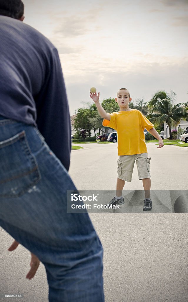 Father and son playing catch outdoors  Adult Stock Photo