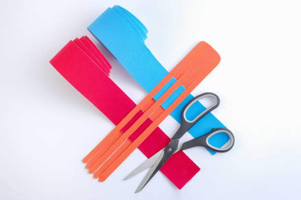istock two rolls kinesiology tape for athletes and scissors on white background, top view. 1186808754