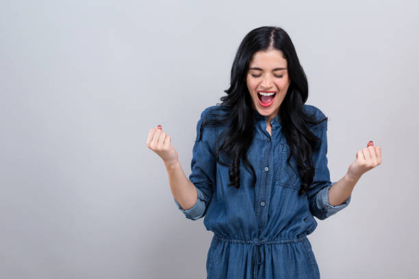 istock Young woman making a yay gesture 1186816610