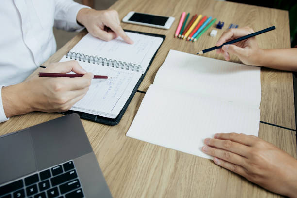 istock Teenager studying at desk and doing homeworks 1186821505