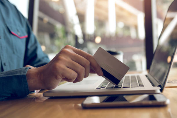istock Man using credit card with shopping online concept at cafe. 1186821606
