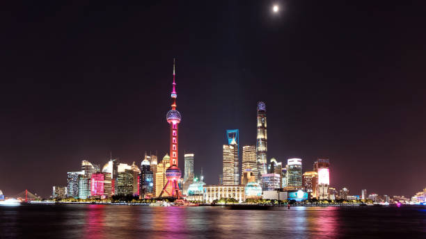 istock Skyline view from Bund waterfront at night with moon on dark blue sky background, Lujiazui is the business quarter of Shanghai, beautiful shanghai night cityscape. 1186822591
