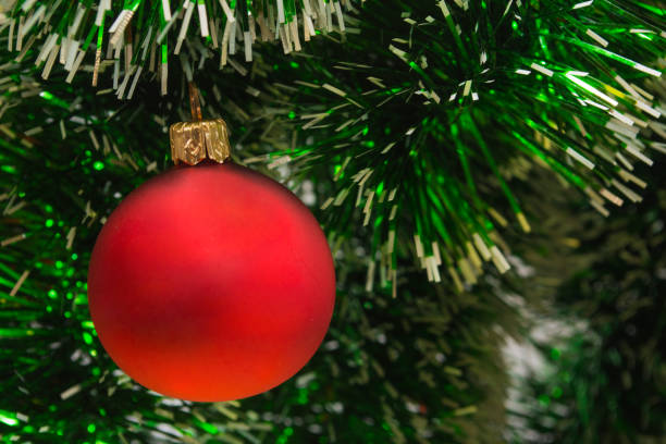 istock A red bubble hanging on a green Christmas tree 1186822717