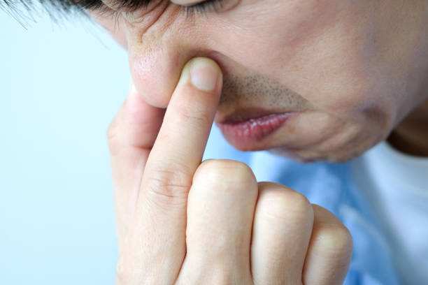 istock The man covered the nose, dodging the bad smell. 1186829079