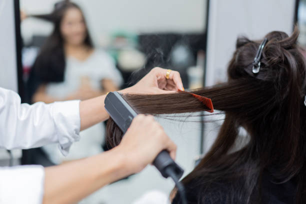 istock Beautician ironing hair customers In a beauty salon 1186830355