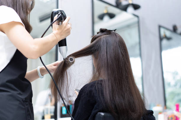 istock Beautician doing hair for customers she is a beautiful woman 1186830372