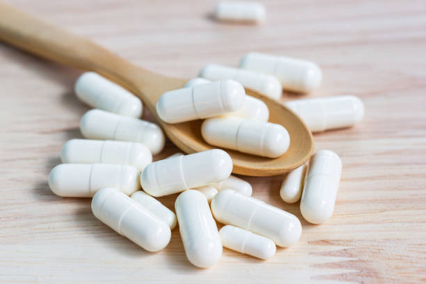 istock the capsules on wood table 1186835250