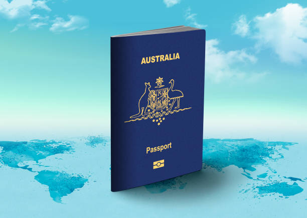 australia passport - official identity document for travel and tourism over world map with clouds in background - emigration and immigration global communications passport australia imagens e fotografias de stock
