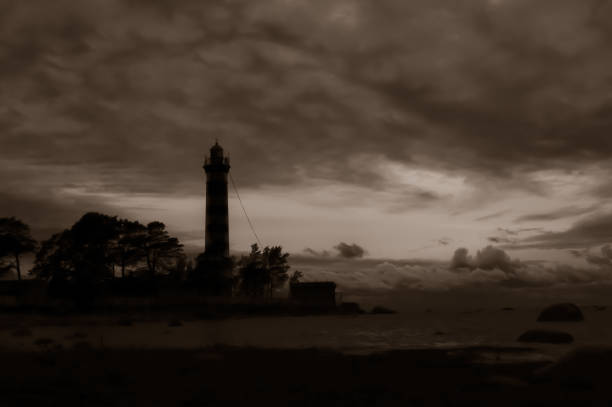 istock High lighthouse tower silhouette in the dark 1186837718