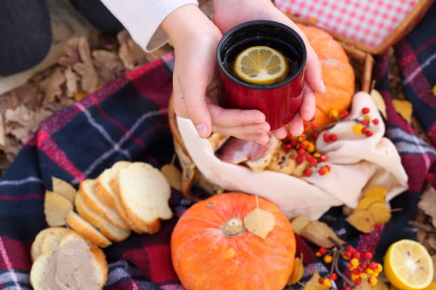 istock hands hold a red mug with tea 1186842375
